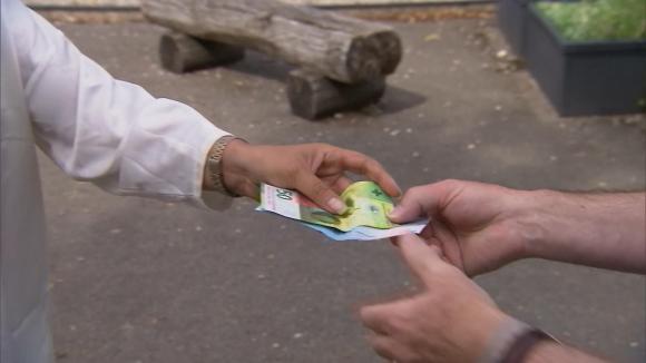 woman handing over money to mayor - close up hands