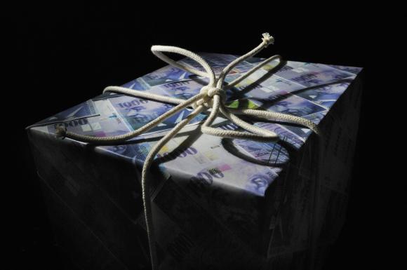 A tied up package with money wrapping