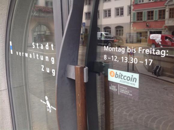 A sticker accepts bitcoin at the door of the Zug municipal offices