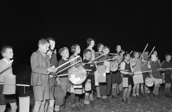 black and white photo of children with lanterns