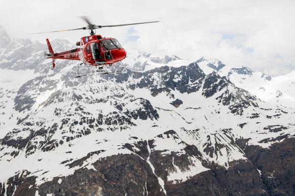 An Air Zermatt helicopter flies near the Matterhorn