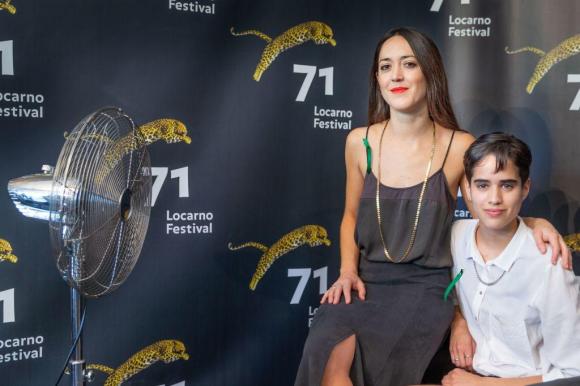 Dos cineastas posando delante del cartel del Festival de Locarno