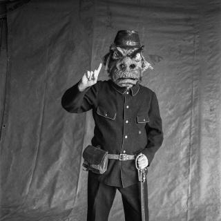 Un homme déguisé en policier, avec un masque