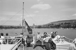 people in the sun on the top deck of a boat