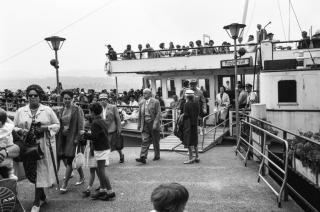 A group of people disembarking a ship.