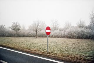 Street sign surrounded by a wintry field