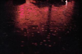 Red light reflection on a wet floor