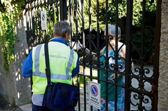 A man an a woman at the gates of a house