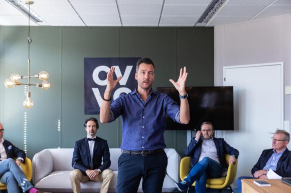 A group of people in front of the CVVC logo