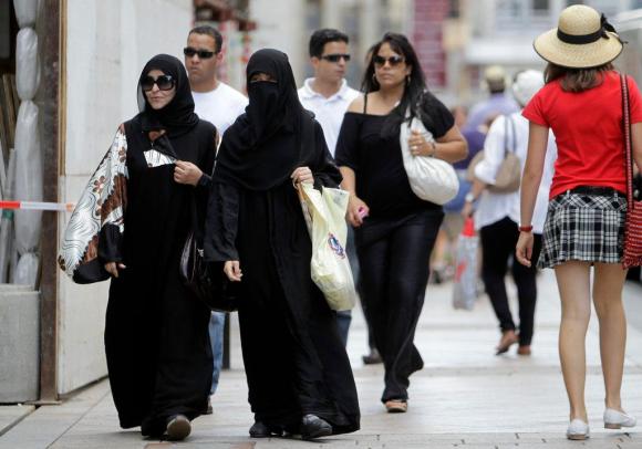 Women in burkas going shopping in Geneva