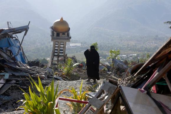 A resident passing through the ruins of a house in Balaroa, central Sulawesi, on Monday