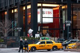 A UBS sign seen from a street in New York.