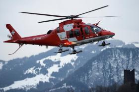 Rega rescue helicopter in mountains
