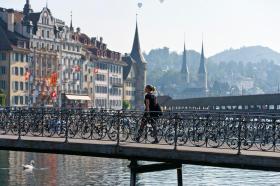 A pedestrian walks across Rathausbruecke bridge in Lucerne