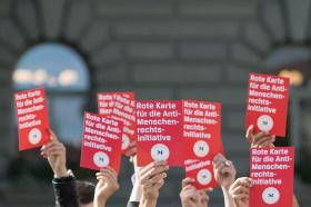 Demonstrators with red cards against perceived attack by People s Party on human rights