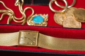 gold wristwatch and bracelets, coins