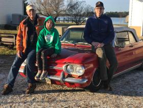 Three generations of the Neville family with a Chevy