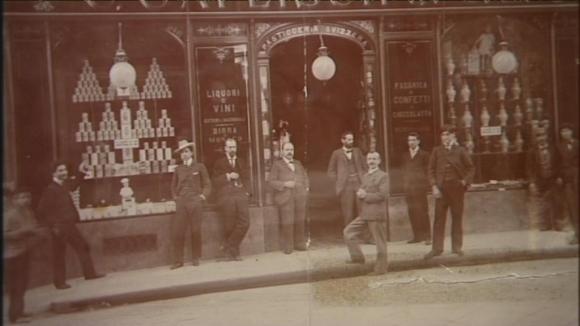 Old photography with men standing in front of a grocery store