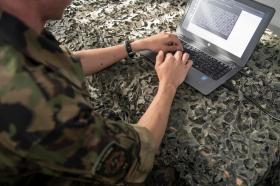 A soldier using a computer