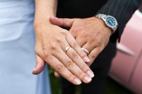 two hands of people getting married
