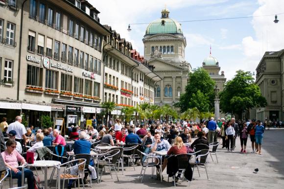 люди за столиками ресторана на улице в Берне