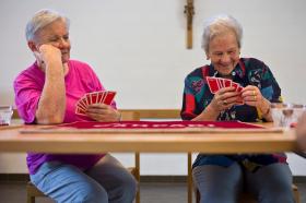 Two older women playing cards