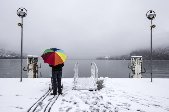 man with umbrella in the snow