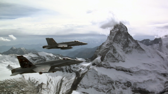 fighter jets flying over mountains