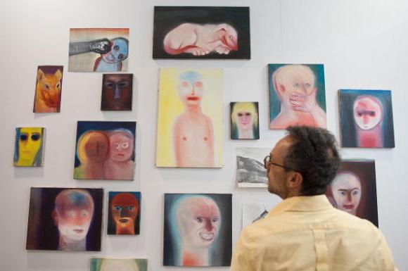 A man looking at art by Miriam Cahn at the Art Basel in Hongkong in 2014