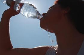 una persona mentre beve da una bottiglia d acqua