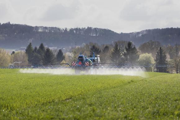 Phytosanitary products being sprayed on a Swiss crop