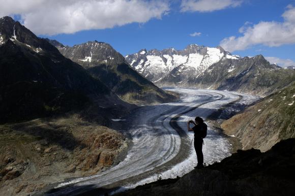 a person takes a picture of a glacier