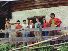 group in front of hut