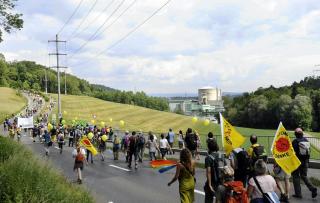 Demonstrators walk down road