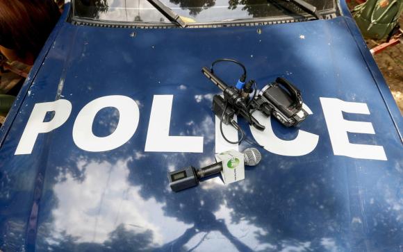 Media equipment sit on a police car in Myanmar