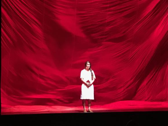 Actress in front of a red curtain