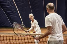 Old couple playing tennis