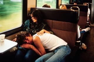 Woman and man asleep in a train