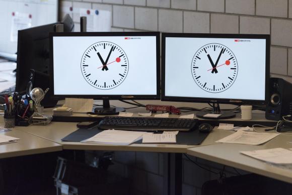 Two railway clocks on computer screens