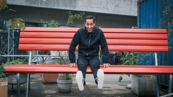 Martin Zimmermann sitting in an oversized park bench
