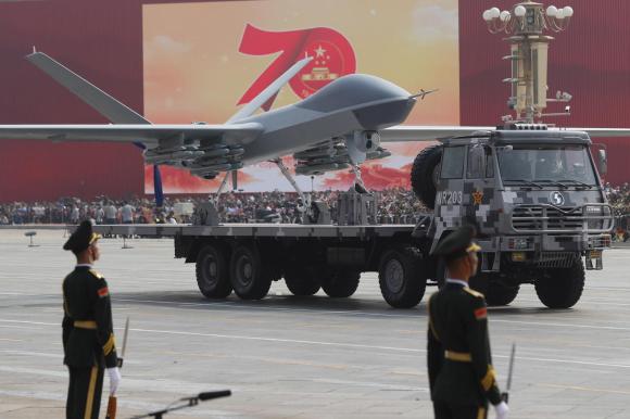 A vehicle carrying an unmanned plane or drone drives past Tiananmen Square, Beijing, China.