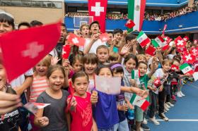 Children line up at the Swiss school in Mexico ahead of a ministerial visit in 2018
