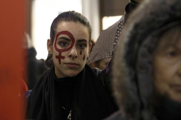 A woman takes part in a rally in Geneva to mark the International Day for the Elimination of Violence against Women.