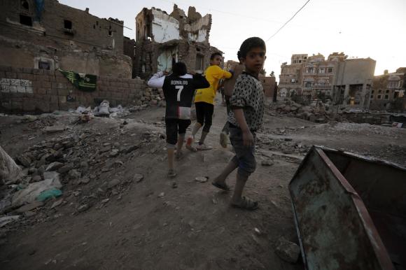 children amid destroyed buildings in Yemen