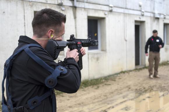 RUAG employees demonstrate an exercise rifle