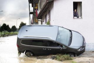 Carro virado de lado por enchente