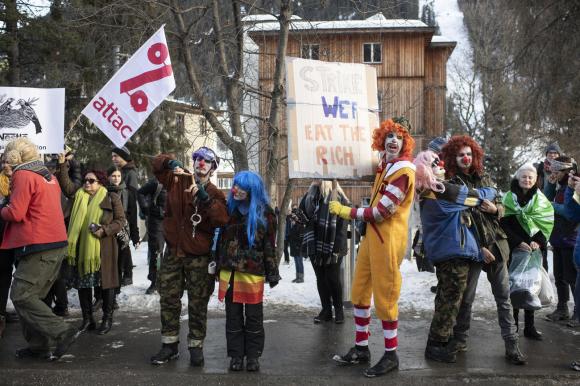 Demonstrators dress as clowns