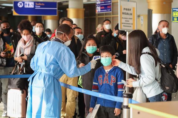 Passengers at airport with face masks