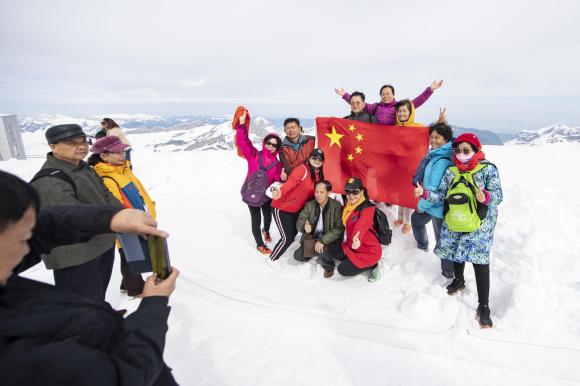 Chinese tourists in the snow posing for pictures