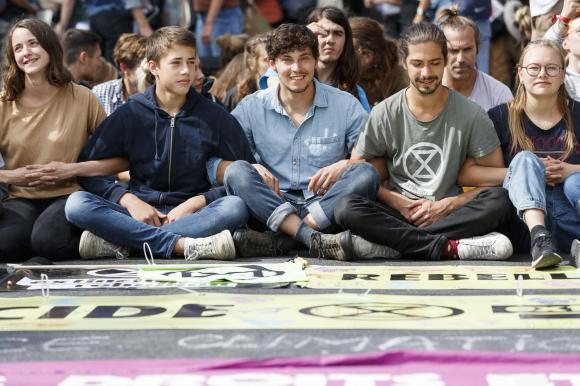 Sit-in protest of young people behind banner